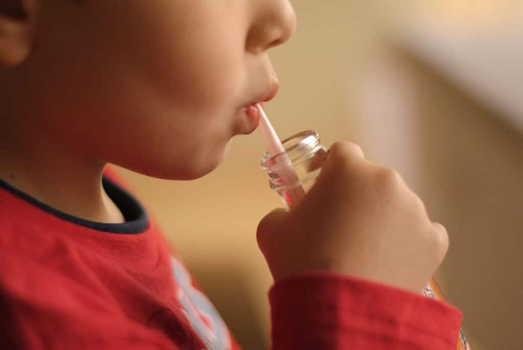 Child drinks through straw