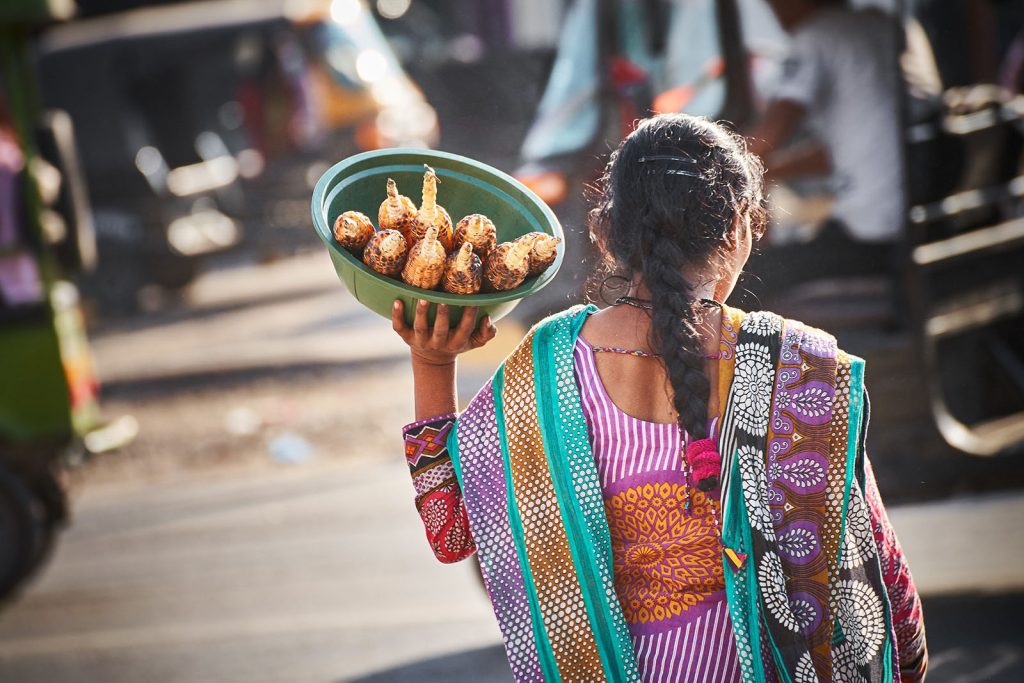 Woman in market in India with corn