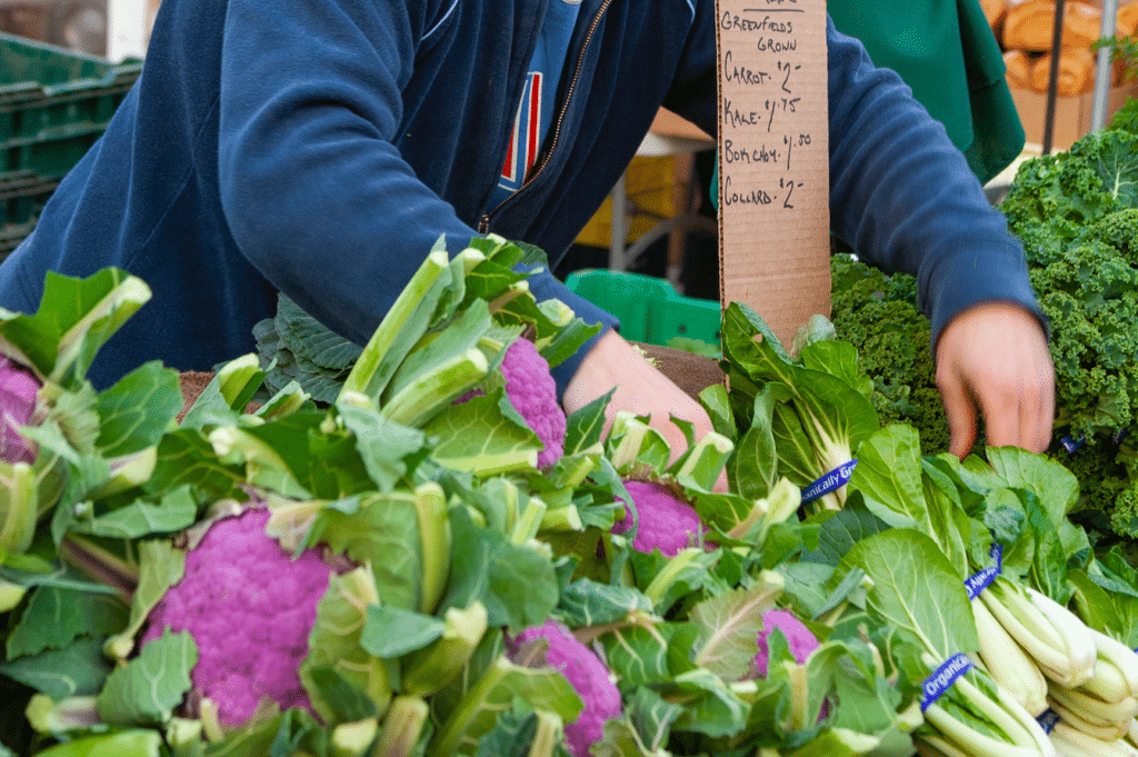 Selling purple cauliflower at a farmers market