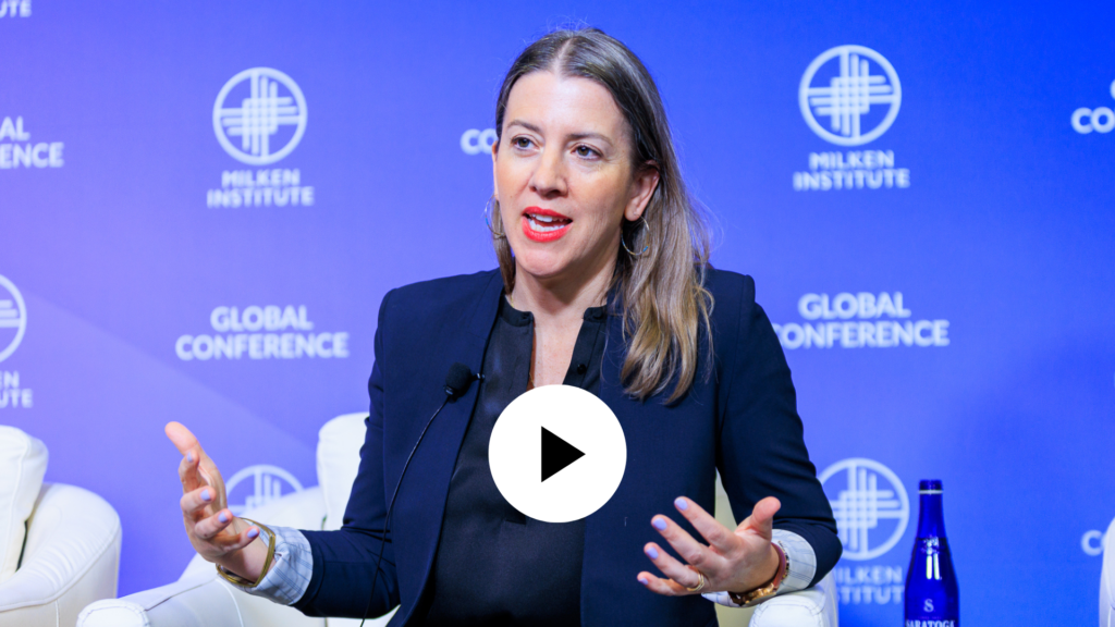 Anna Lappe wearing a blue suit is pictured speaking at the Milken Institute Global Conference